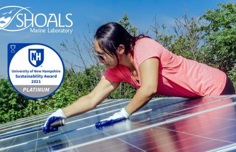 A woman works on a solar panel and a graphic states "UNH Sustainability Award 2021 Platinum"