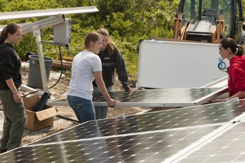 Women install solar panels