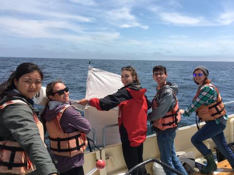 a group of young students working on the ocean