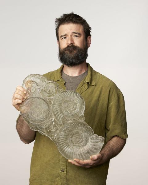 bearded man with glass fossils