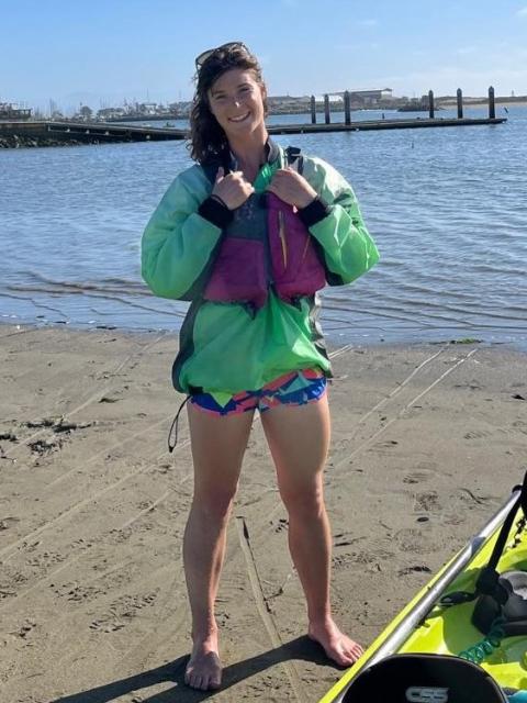 woman on beach wearing life vest