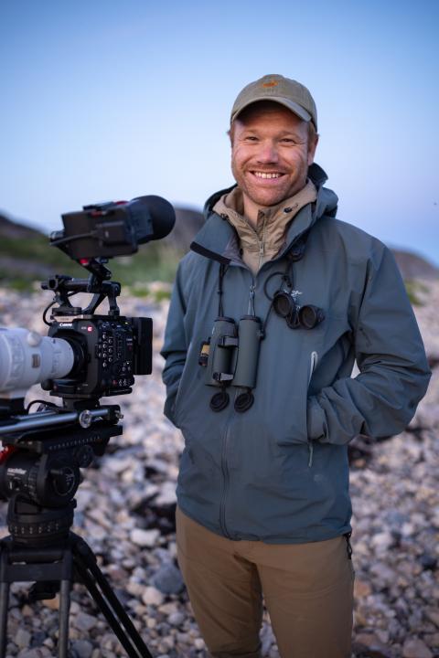 a man in hat with photography gear