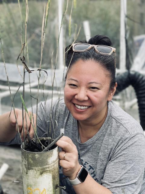 woman with can of plant stems