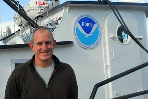 a man in a NOAA boat